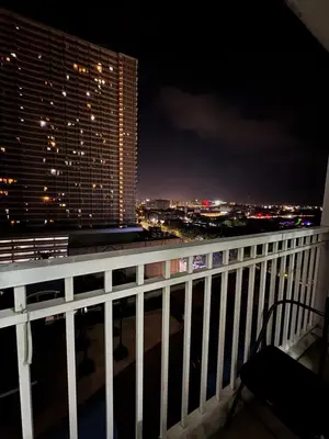 a balcony with a view of a city at night at Condo in Pasay in Manila