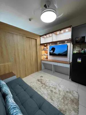 a living room with a couch and a flat screen tv at Condo in Pasay in Manila