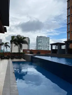 a swimming pool on the roof of a building at Porto Vita 2BR in Manila