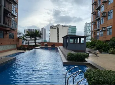 a swimming pool in the middle of a city with buildings at Porto Vita 2BR in Manila