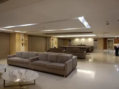 a lobby with couches and tables in a building at Affordable staycation in Pasay-Breeze Residence in Manila