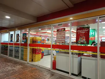 a store aisle of a grocery store with glass doors at Affordable staycation in Pasay-Breeze Residence in Manila