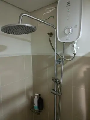 a shower with a shower head in a bathroom at Affordable staycation in Pasay-Breeze Residence in Manila
