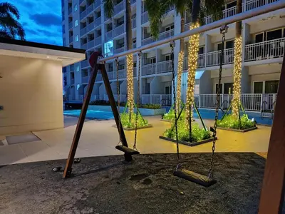 an empty swings in front of a building at Affordable staycation in Pasay-Breeze Residence in Manila