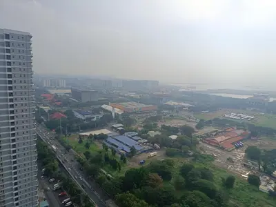 an aerial view of a city with a tall building at Affordable staycation in Pasay-Breeze Residence in Manila