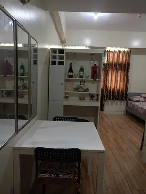 a room with a white table and chairs in a room at Holland Park Condominium Accommodation Southwoods Biñan Laguna- Max 4 Persons including kids & toddlers in Biñan