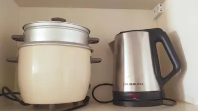 a slow cooker and a toaster on a counter at Holland Park Condominium Accommodation Southwoods Biñan Laguna- Max 4 Persons including kids & toddlers in Biñan
