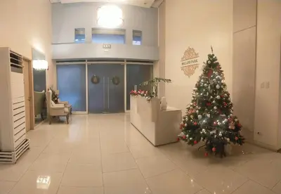 a christmas tree in the middle of a lobby at Holland Park Condominium Accommodation Southwoods Biñan Laguna- Max 4 Persons including kids & toddlers in Biñan