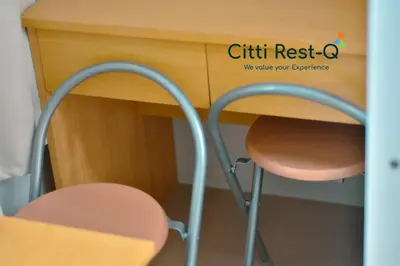 a desk with a chair next to a wooden desk at Studio City Alabang Pool Access Free for 2 Wifi & Netflix SC2 in Manila