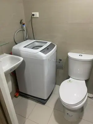 a small bathroom with a toilet and a sink at Mall of Asia Staycation by Mochi - SMDC Shore 2 Tower 3 in Manila
