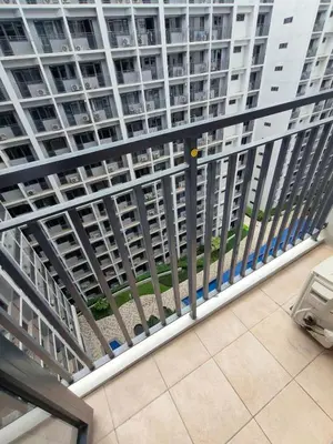 a balcony with a metal railing in a building at Mall of Asia Staycation by Mochi - SMDC Shore 2 Tower 3 in Manila