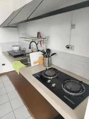 a kitchen with a stove and a sink at Solace View Rooftop in Manila
