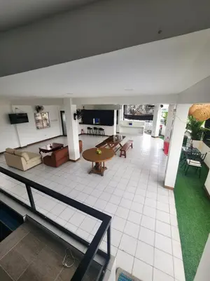 a large room with a table and a couch at Solace View Rooftop in Manila