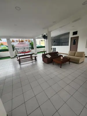 a living room with couches and tables on a tile floor at Solace View Rooftop in Manila