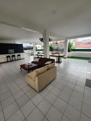 a living room with a couch and a table at Solace View Rooftop in Manila