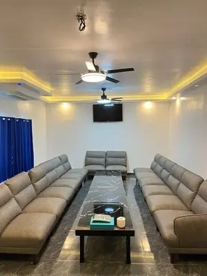 a living room with a couch and a table at Shiri Pool Villa 1 in Silang