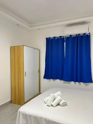 a bedroom with a bed with a blue curtain at Shiri Pool Villa 1 in Silang