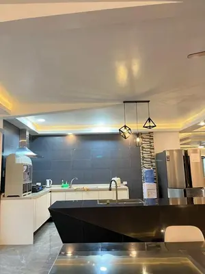 a large kitchen with a sink and a counter top at Shiri Pool Villa 1 in Silang
