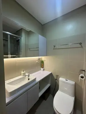 a bathroom with a toilet and a sink and a mirror at Ustays in comfort and style in Manila
