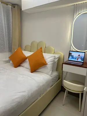 a bedroom with a bed and a laptop on a table at Ustays in comfort and style in Manila