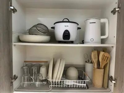 a cupboard filled with lots of kitchen utensils at Ustays in comfort and style in Manila