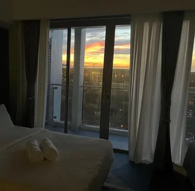 a hotel room with a bed and a large window at Luxurious Modern Penthouse 2BR Cross City of Dreams OKADA SOLAIRE MOA Airports in Manila
