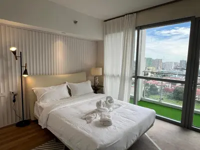 a bedroom with a bed with a teddy bear on it at Luxurious Modern Penthouse 2BR Cross City of Dreams OKADA SOLAIRE MOA Airports in Manila
