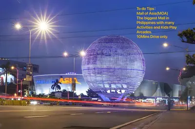 a large building in a city at night at Luxurious Modern Penthouse 2BR Cross City of Dreams OKADA SOLAIRE MOA Airports in Manila