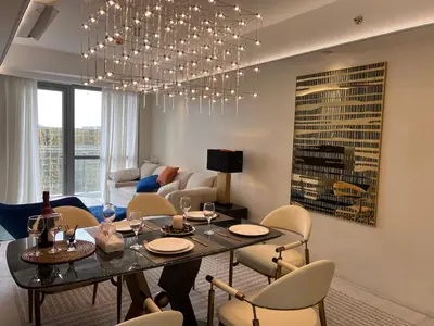 a living room with a dining table and chairs at Luxurious Modern Penthouse 2BR Cross City of Dreams OKADA SOLAIRE MOA Airports in Manila
