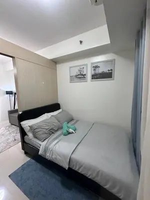 a bedroom with a bed with a blue shoe on it at Minamalist modern Condo with Chic touches 