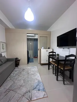 a living room with a couch and a table at Minamalist modern Condo with Chic touches 