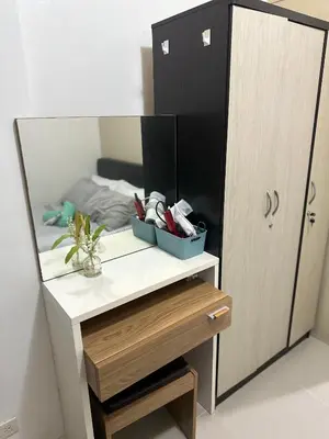 a dressing table with a mirror next to a bed at Minamalist modern Condo with Chic touches 