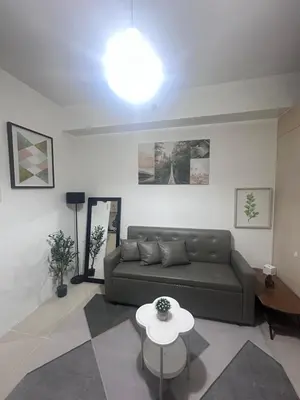 a living room with a couch and a table at Minamalist modern Condo with Chic touches 
