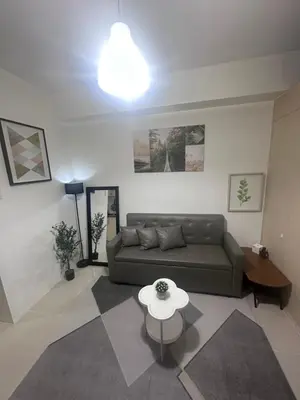 a living room with a couch and a table at Minamalist modern Condo with Chic touches 