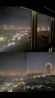 a view of a city at night from a window at AD Camp in Manila