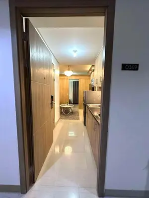 an open door to a kitchen with a hallway at Shore 2 Residences, 1BR Balcony - Pool view in Manila