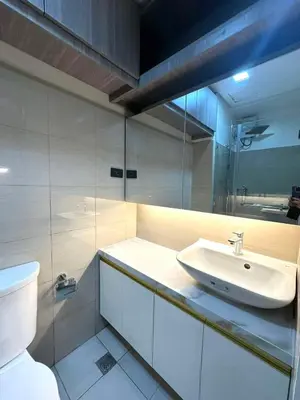 a bathroom with a sink and a toilet at Shore 2 Residences, 1BR Balcony - Pool view in Manila