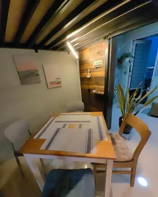 a wooden table and chair in a room at Condo Unit at SMDC Breeze Residences with a view in Manila