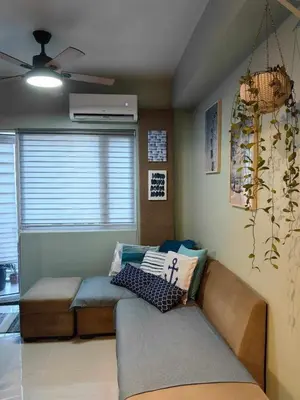 a living room with a couch and a window at Condo Unit at SMDC Breeze Residences with a view in Manila