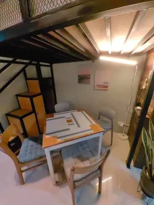 a living room with a table and chairs and a couch at Condo Unit at SMDC Breeze Residences with a view in Manila
