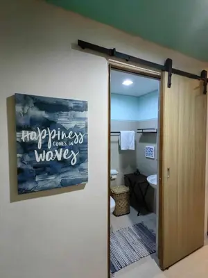 a bathroom with a painting on the wall at Condo Unit at SMDC Breeze Residences with a view in Manila