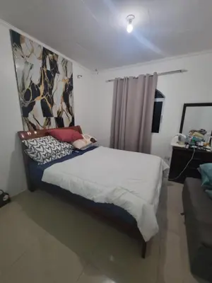 a bedroom with a large bed in a room at Verona Subdivision in Matangtubig