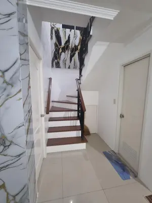 a staircase in a house with a painting on the wall at Verona Subdivision in Matangtubig
