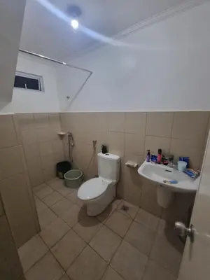 a bathroom with a toilet and a sink at Verona Subdivision in Matangtubig