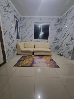 a living room with a couch and a marble wall at Verona Subdivision in Matangtubig