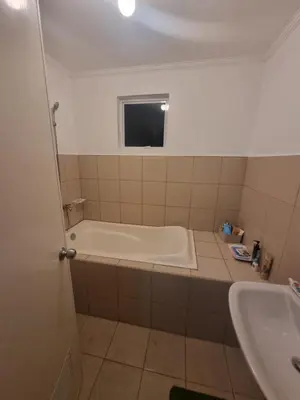 a bathroom with a tub and a sink at Verona Subdivision in Matangtubig