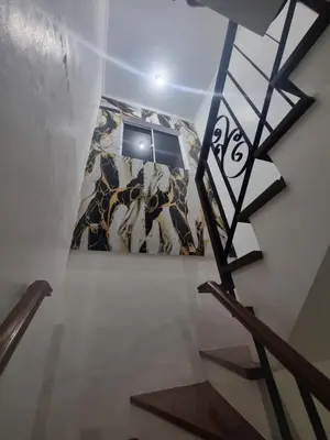 a staircase in a room with a painting on the wall at Verona Subdivision in Matangtubig