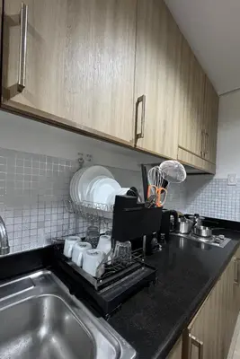 a kitchen with a sink and a counter top at Shore Oasis Manila Near Mall of Asia in Manila