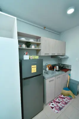a kitchen with a sink and a refrigerator at Studio City Alabang Pool Access Free for 2 Wifi & Netflix SC3 in Manila