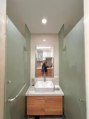 a person taking a picture of a bathroom sink at Sunset Studio in Manila